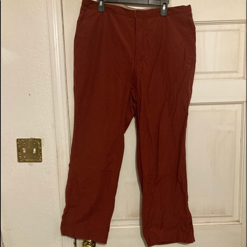 Claret Stovepipe Pants with flap close back pockets & side slit pockets.